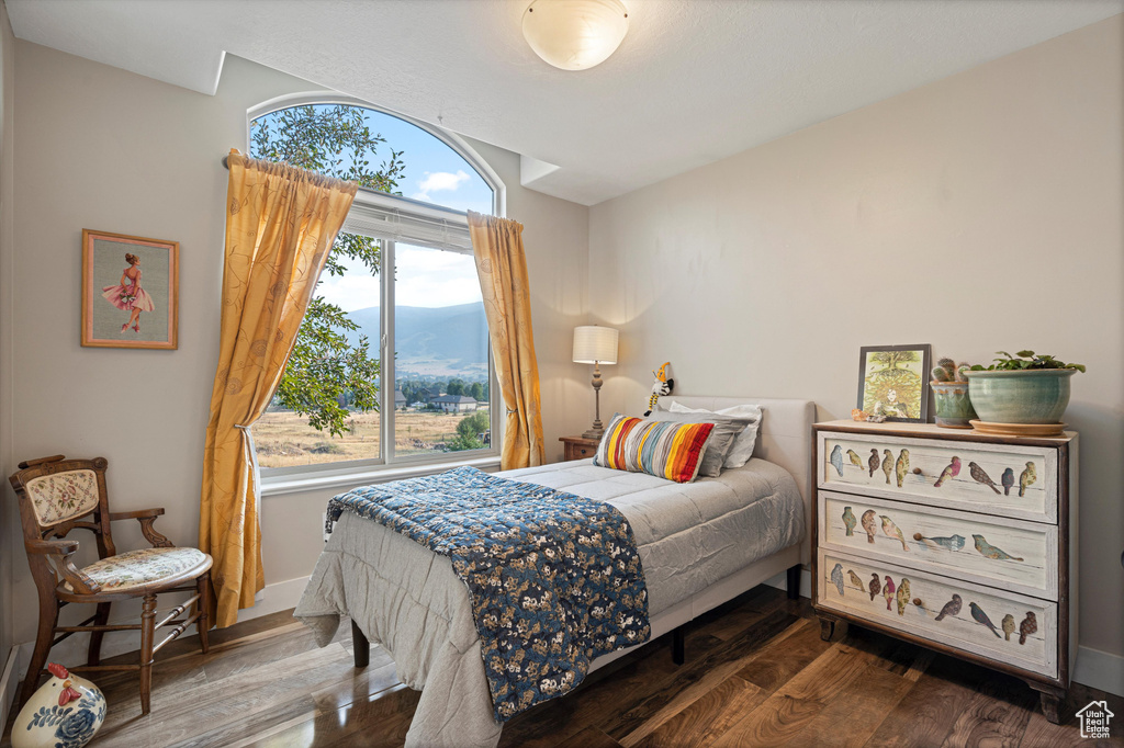 Bedroom featuring wood-type flooring and a mountain view