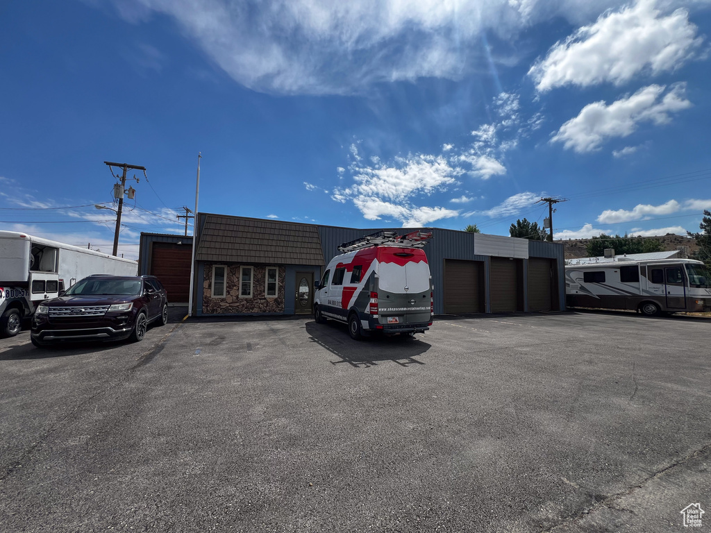 View of car parking featuring a garage