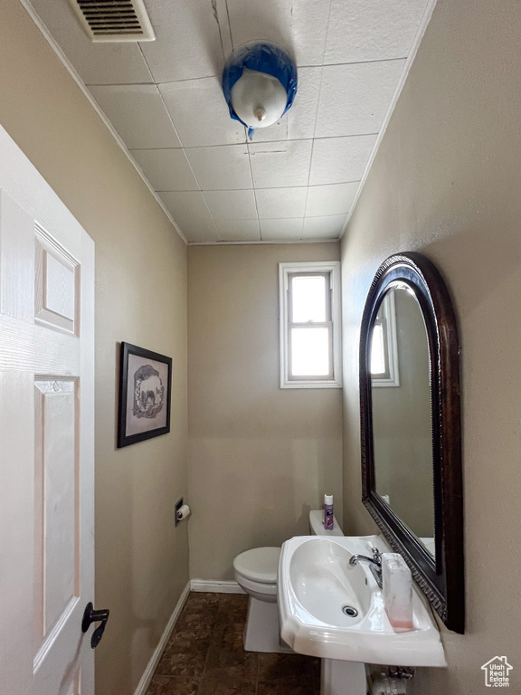 Bathroom with sink, tile patterned flooring, and toilet