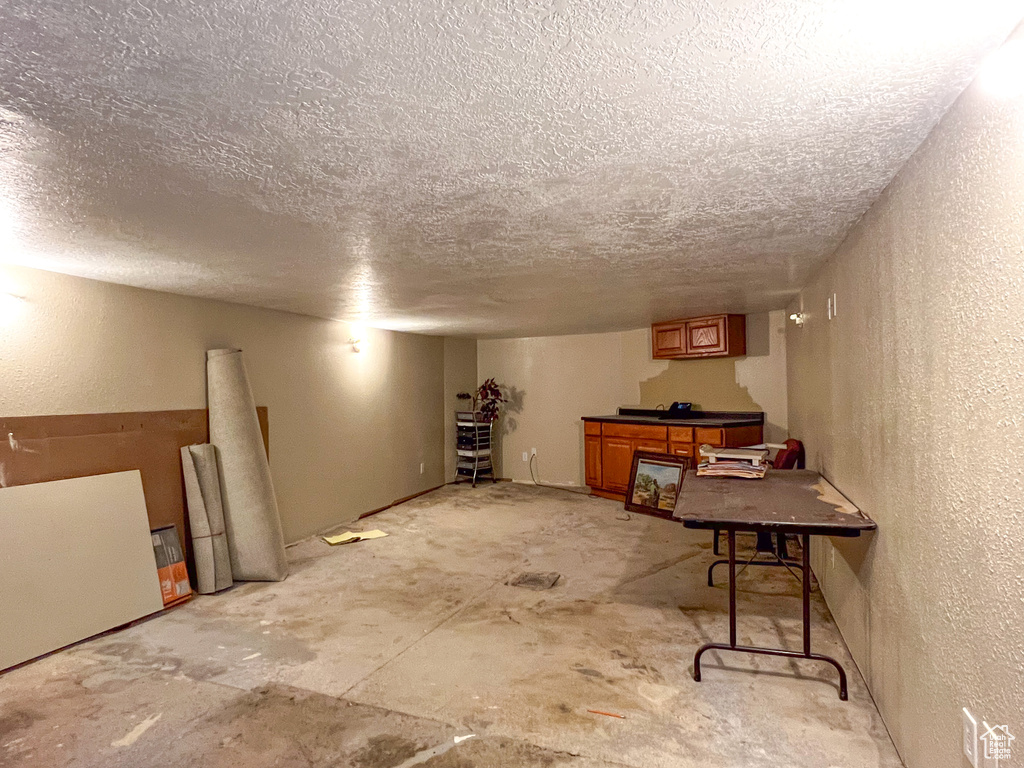 Basement with a textured ceiling