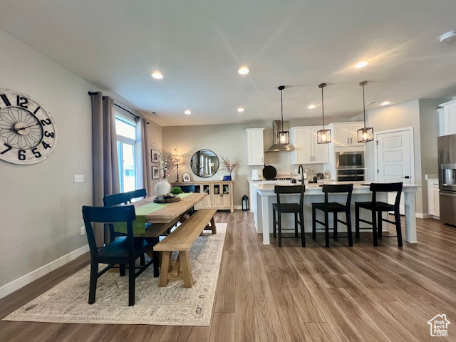 Dining room with sink and wood-type flooring