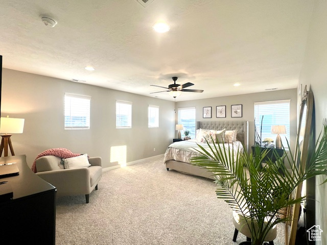 Bedroom featuring ceiling fan and carpet