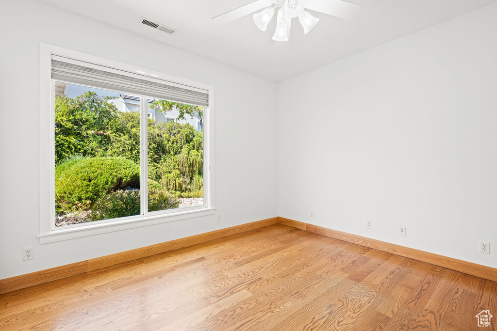 Unfurnished room featuring ceiling fan and light hardwood / wood-style floors