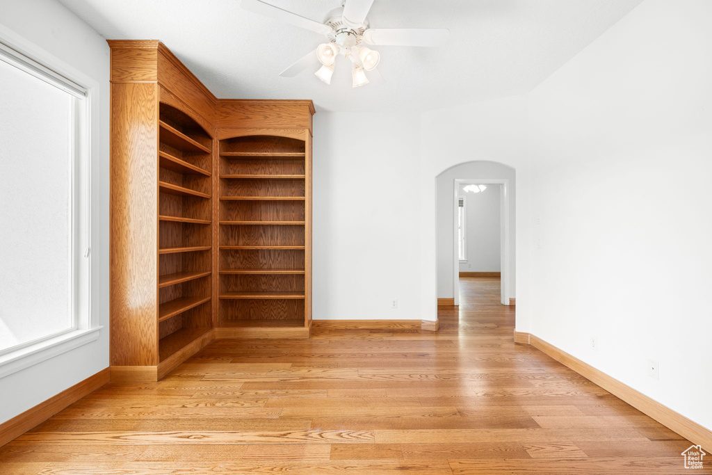 Empty room featuring light wood-type flooring and ceiling fan