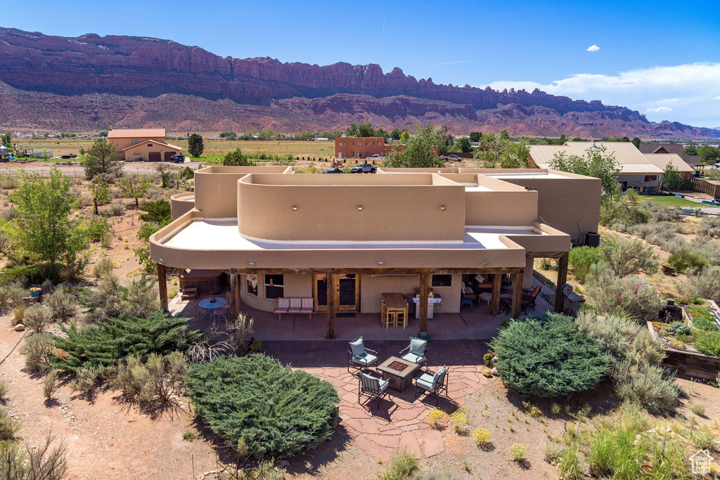 Exterior space featuring a patio and a mountain view