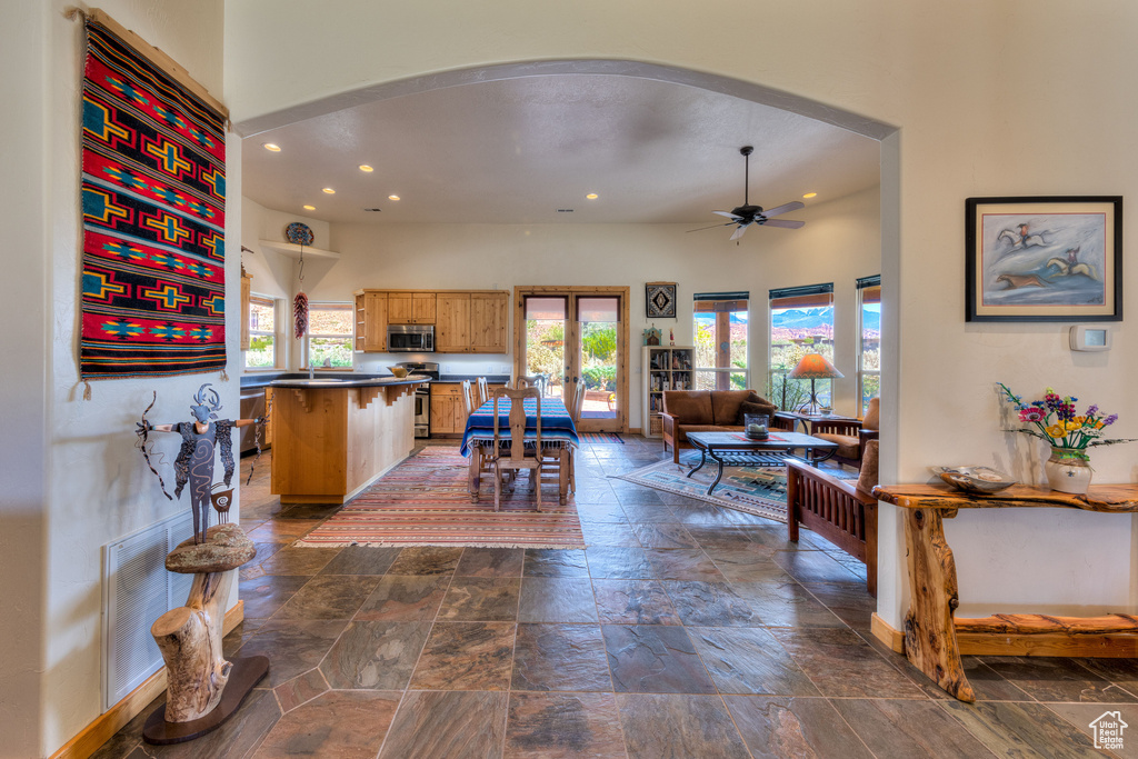 Kitchen with ceiling fan, a wealth of natural light, dark tile patterned floors, and french doors