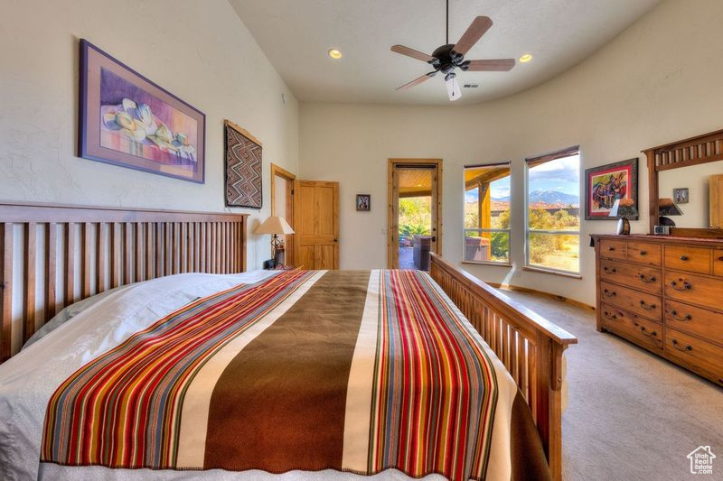 Bedroom featuring a towering ceiling, ceiling fan, and carpet floors