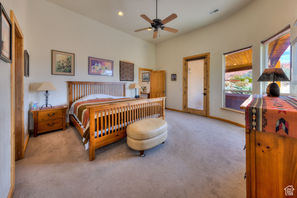 Carpeted bedroom with access to outside and ceiling fan