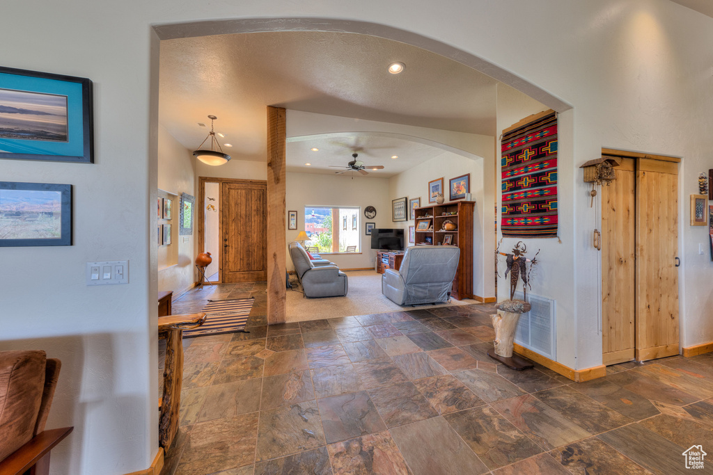 Tiled entrance foyer featuring ceiling fan