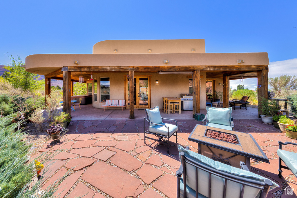 View of patio / terrace featuring an outdoor living space with a fire pit