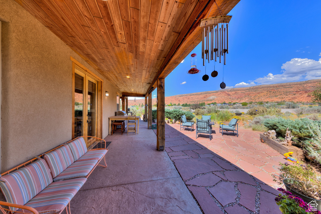 View of patio with a mountain view and an outdoor living space