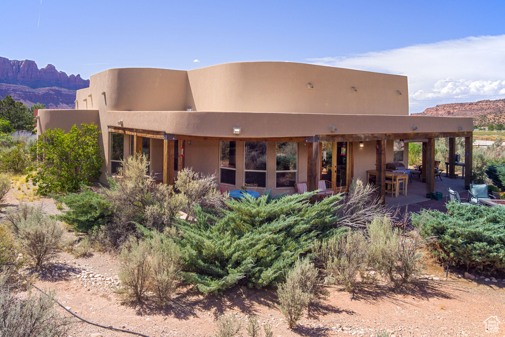 Back of house featuring a patio and a mountain view