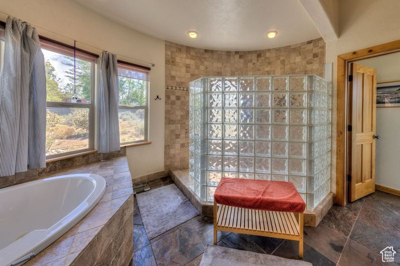 Bathroom with tile patterned floors and plus walk in shower