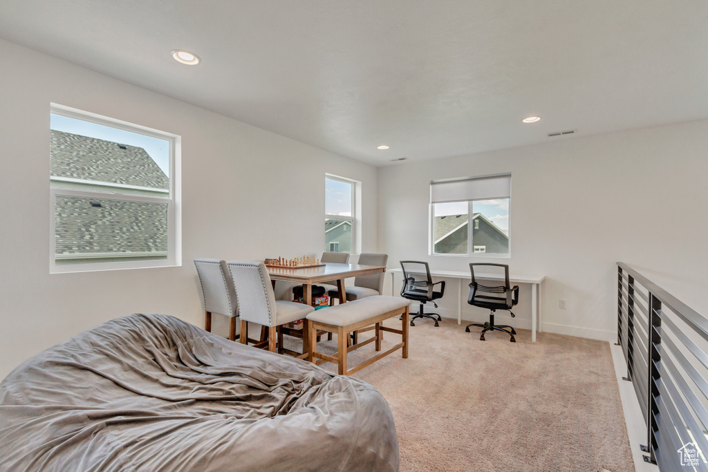 Bedroom featuring light colored carpet