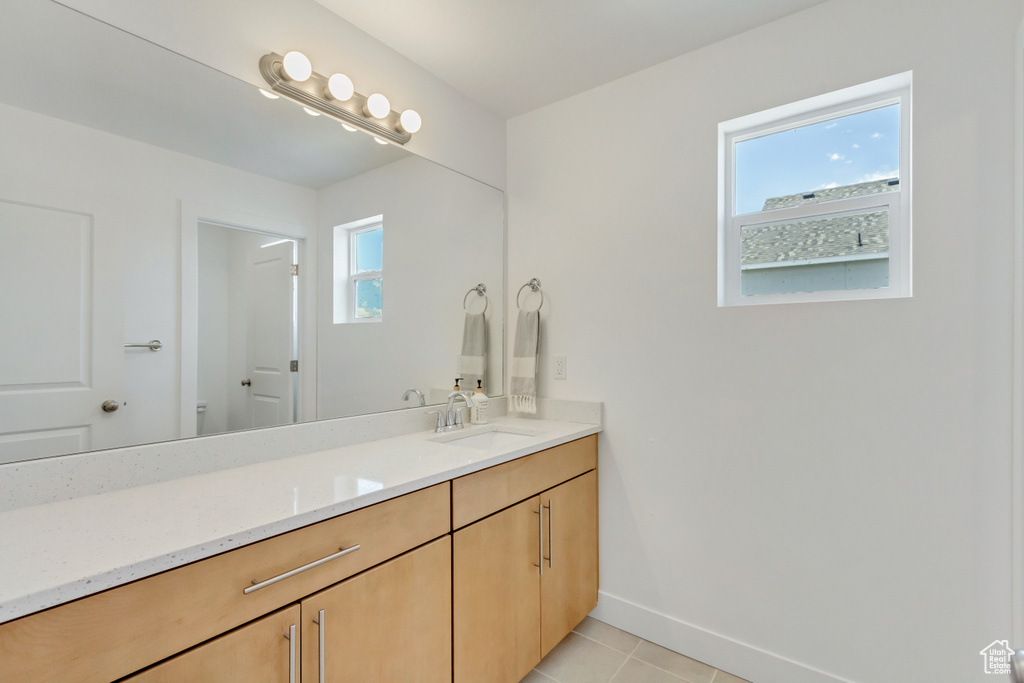 Bathroom with tile patterned floors and vanity