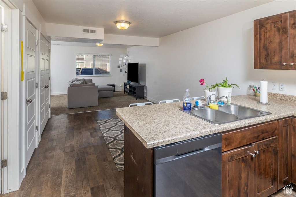 Kitchen featuring dishwasher, sink, dark wood-type flooring, and dark brown cabinetry