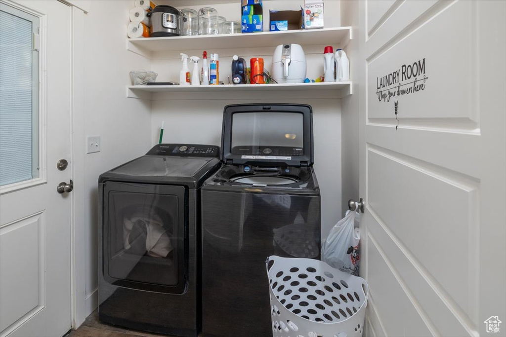 Clothes washing area featuring washer and clothes dryer