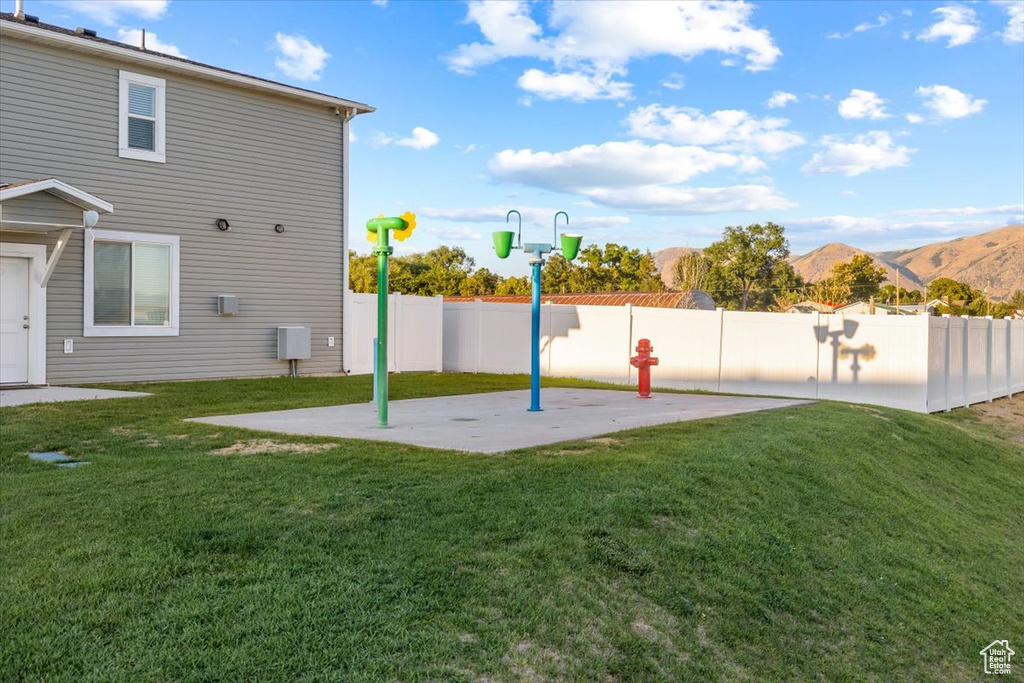 View of yard with a patio and a mountain view