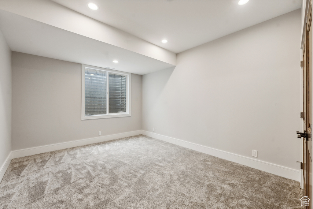 Unfurnished room featuring light colored carpet