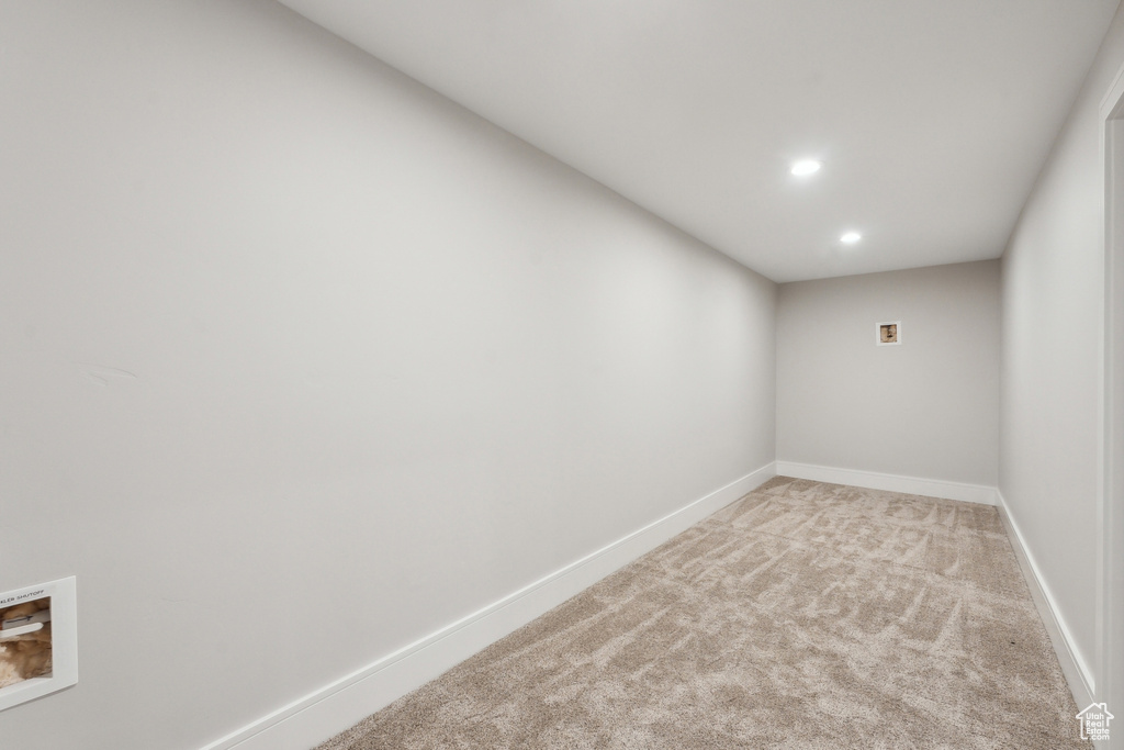 Basement featuring light colored carpet