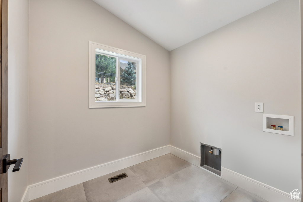 Washroom featuring light tile patterned floors and washer hookup