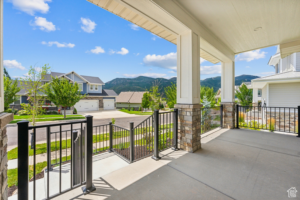 Balcony featuring covered porch and a mountain view