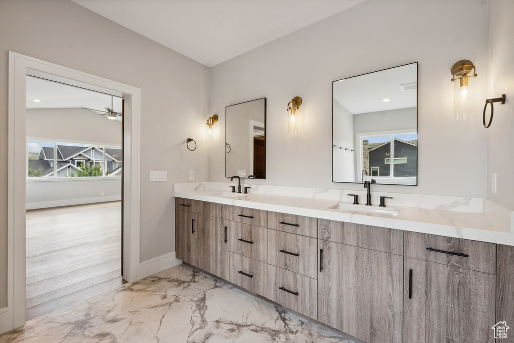 Bathroom with dual bowl vanity, wood-type flooring, and vaulted ceiling