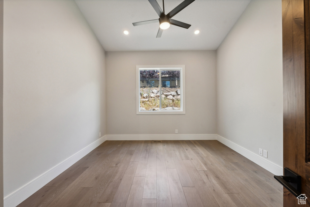 Spare room with hardwood / wood-style floors and ceiling fan