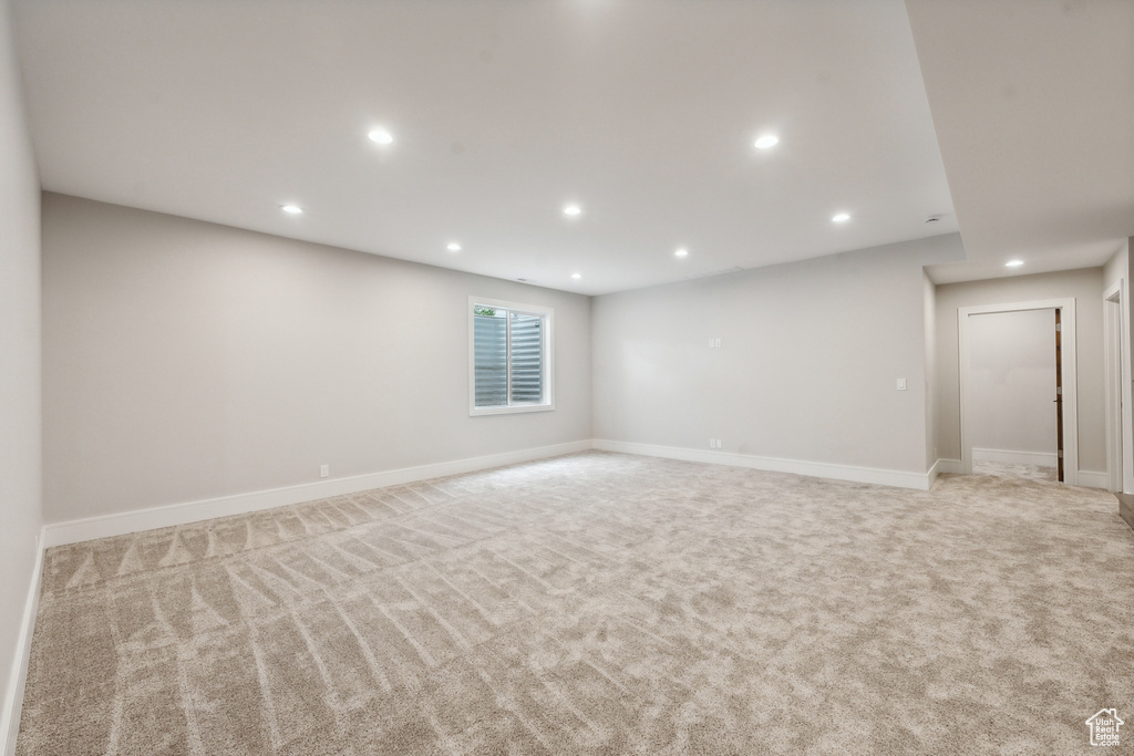 Empty room featuring light colored carpet