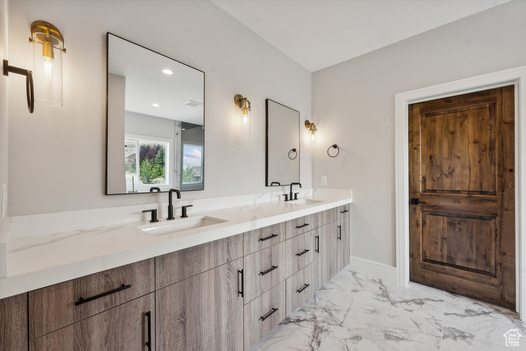 Bathroom featuring double vanity and tile patterned floors