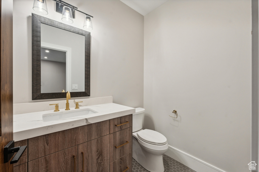 Bathroom featuring tile patterned floors, vanity, and toilet