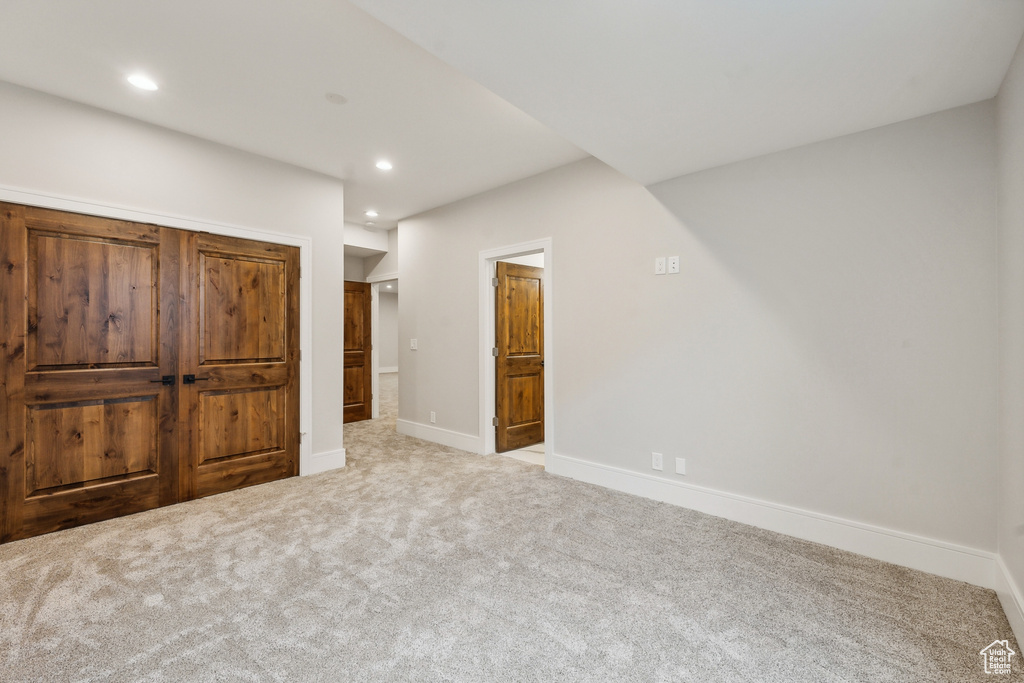 Unfurnished bedroom featuring light colored carpet