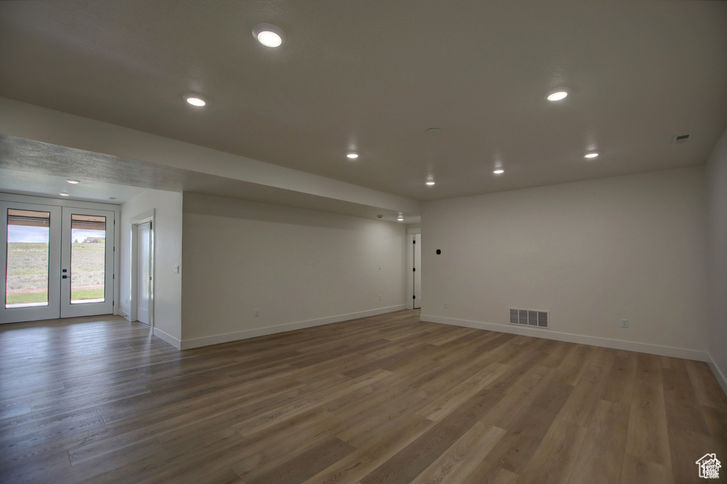 Empty room featuring french doors and wood-type flooring