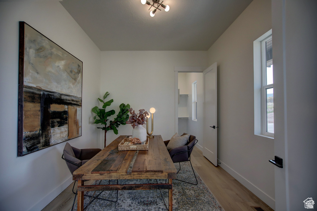 Office with light hardwood / wood-style flooring