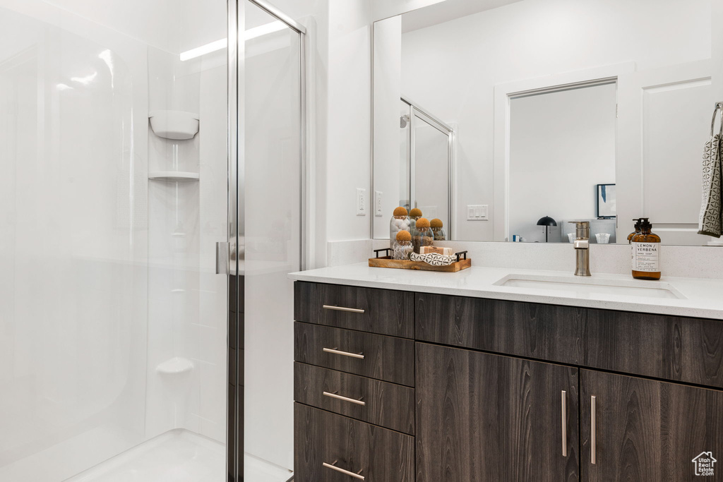 Bathroom featuring vanity and a shower with shower door