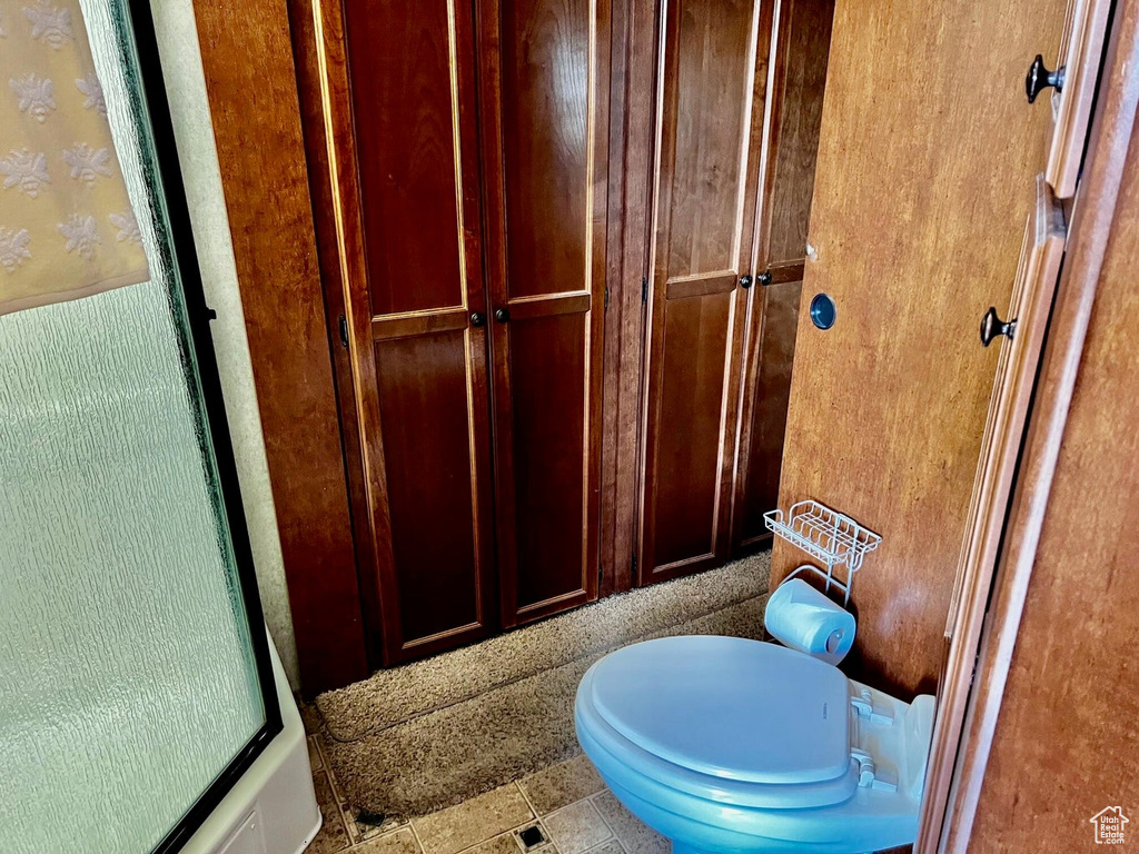 Bathroom featuring tile patterned flooring and toilet