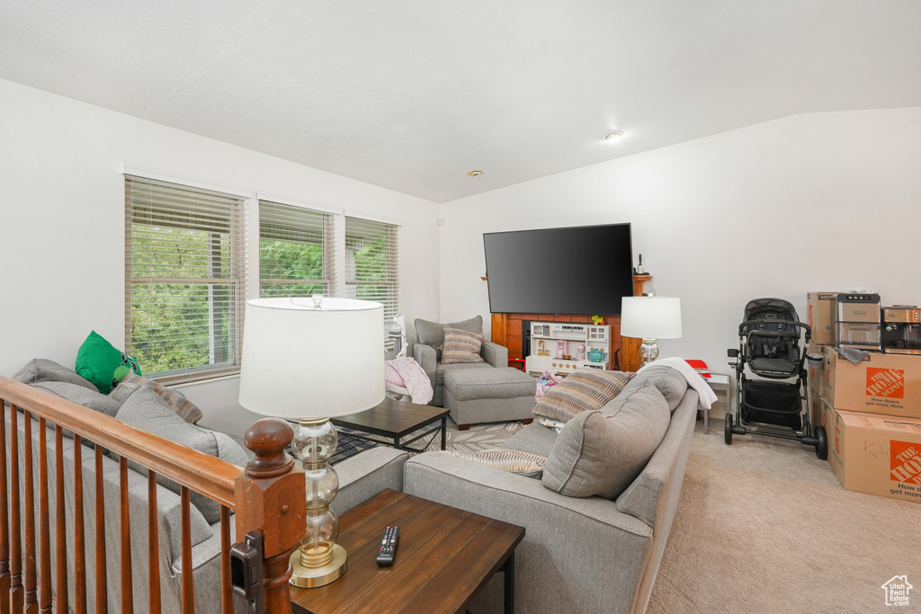 Carpeted living room with vaulted ceiling