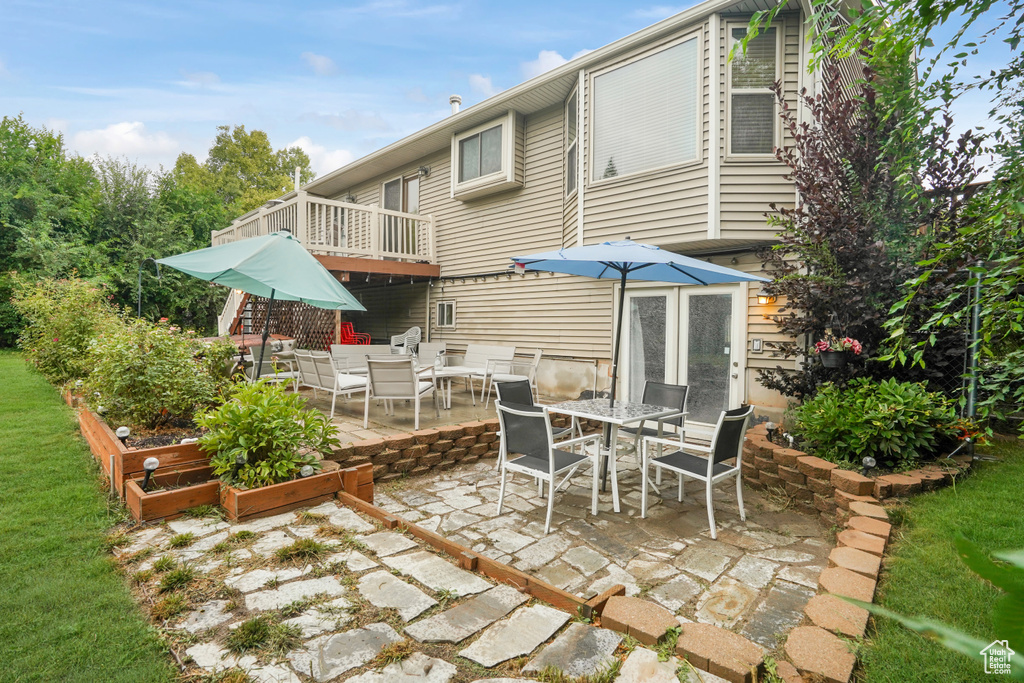 Back of house featuring a patio and a balcony