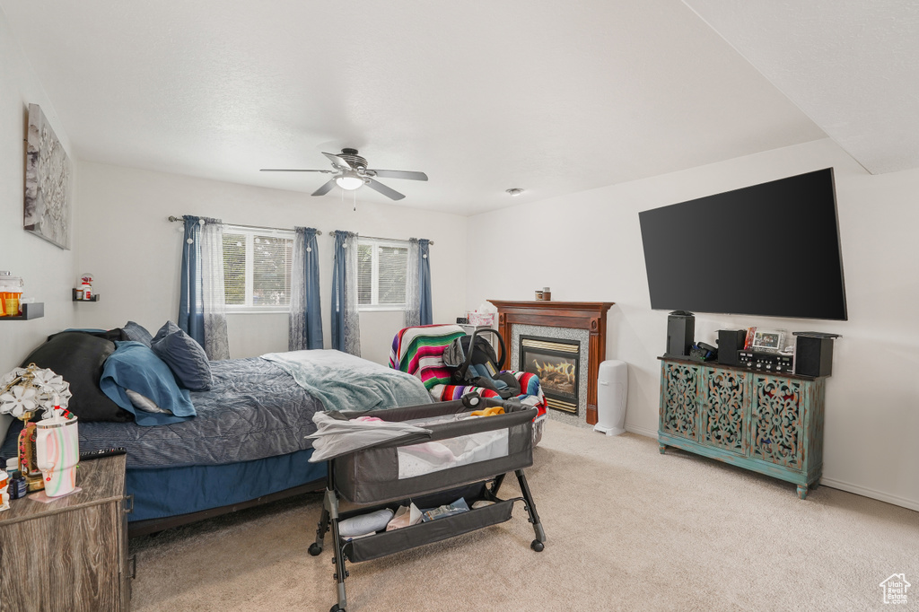 Carpeted bedroom featuring ceiling fan