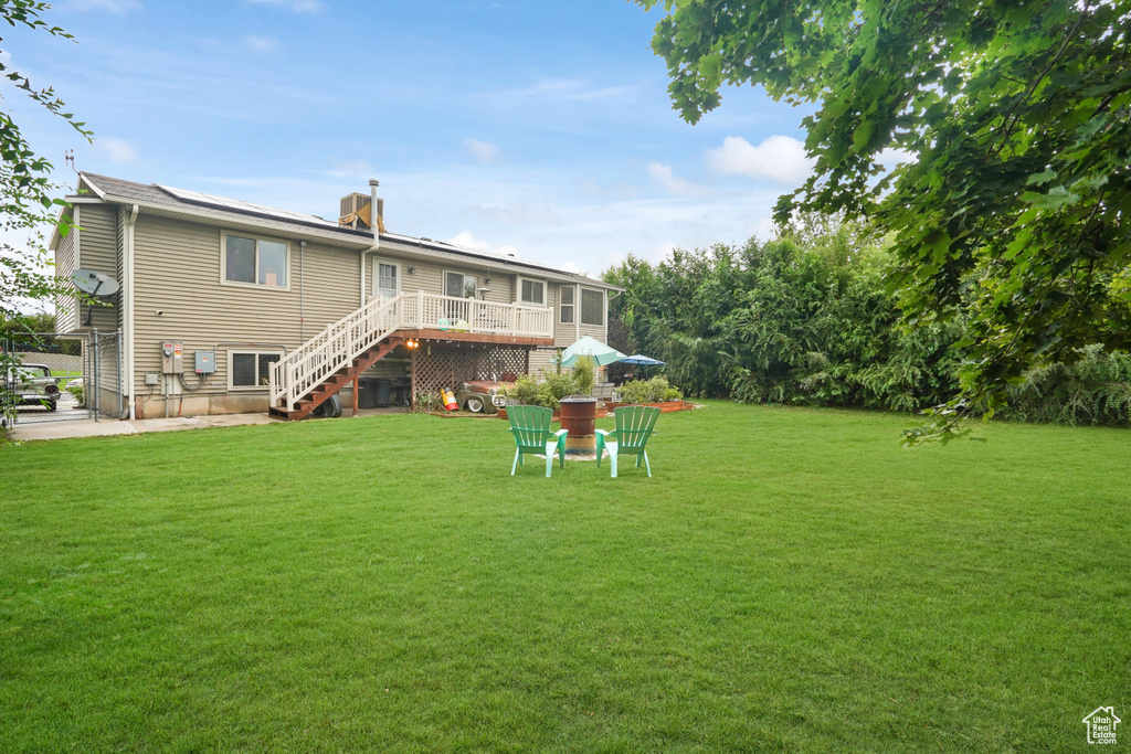 Rear view of house featuring a yard