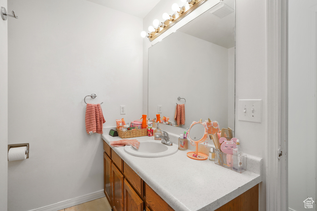 Bathroom with tile patterned floors and vanity