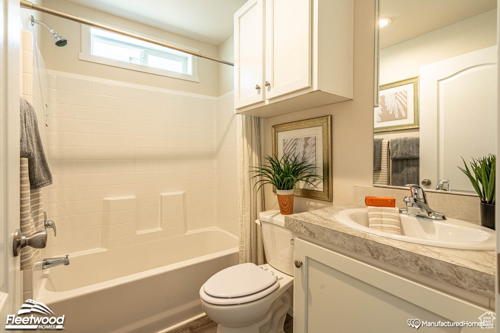 Full bathroom with vanity, bathing tub / shower combination, and toilet