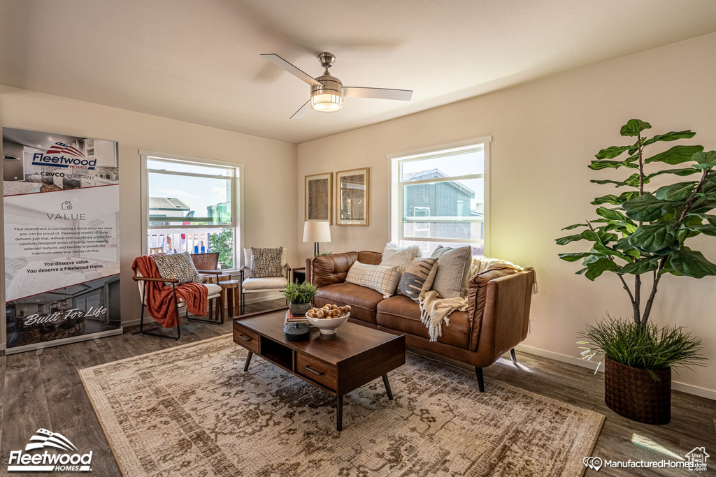 Living room with ceiling fan and hardwood / wood-style floors