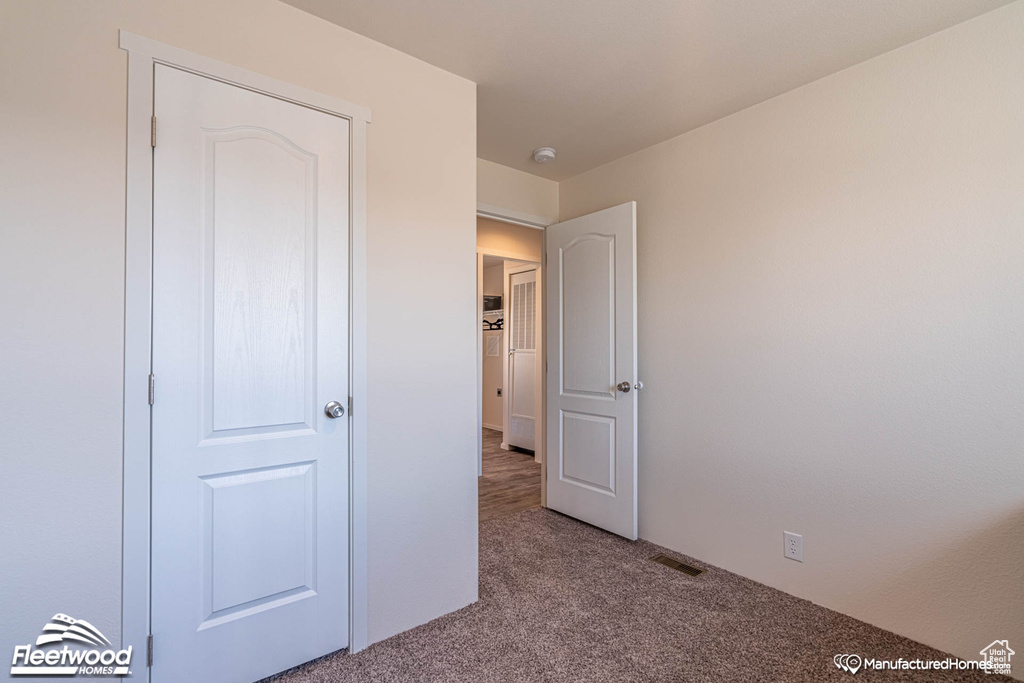 Unfurnished bedroom featuring carpet flooring