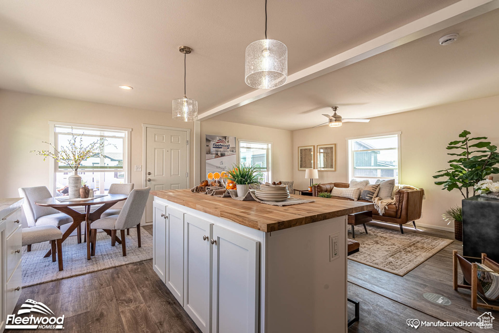 Kitchen featuring dark hardwood / wood-style floors, wooden counters, and plenty of natural light