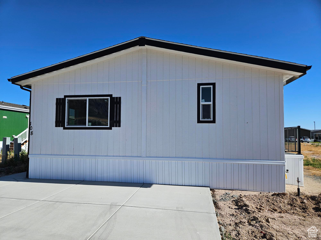 View of side of home with a patio