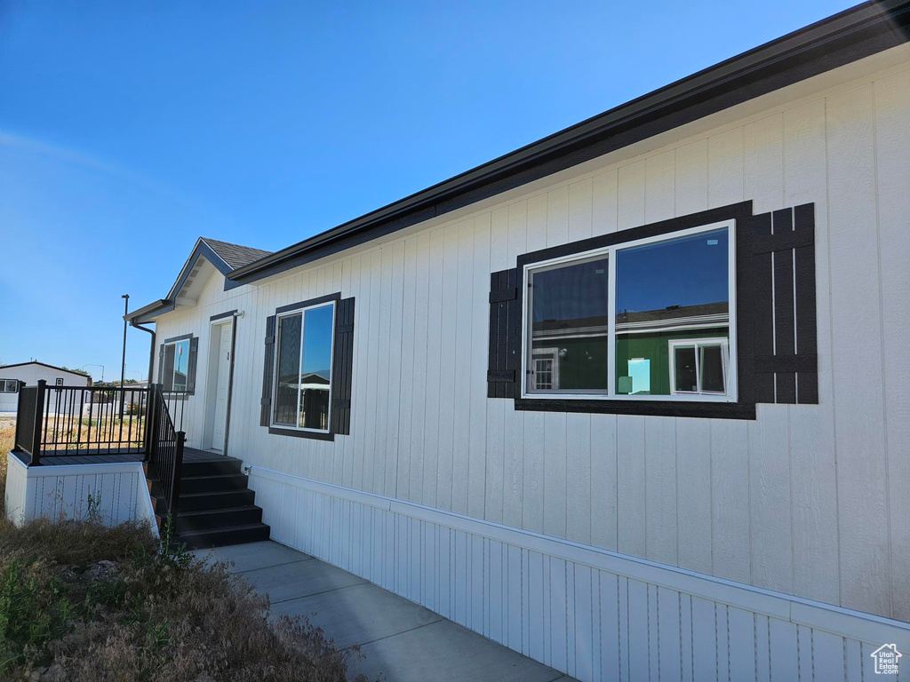 View of property exterior featuring a deck