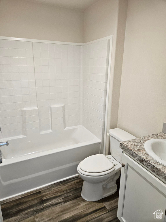 Full bathroom featuring vanity, shower / washtub combination, toilet, and hardwood / wood-style floors