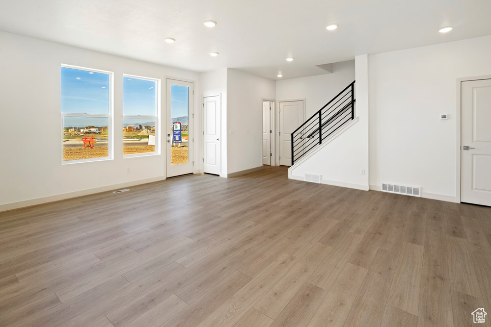 Unfurnished living room featuring light hardwood / wood-style flooring