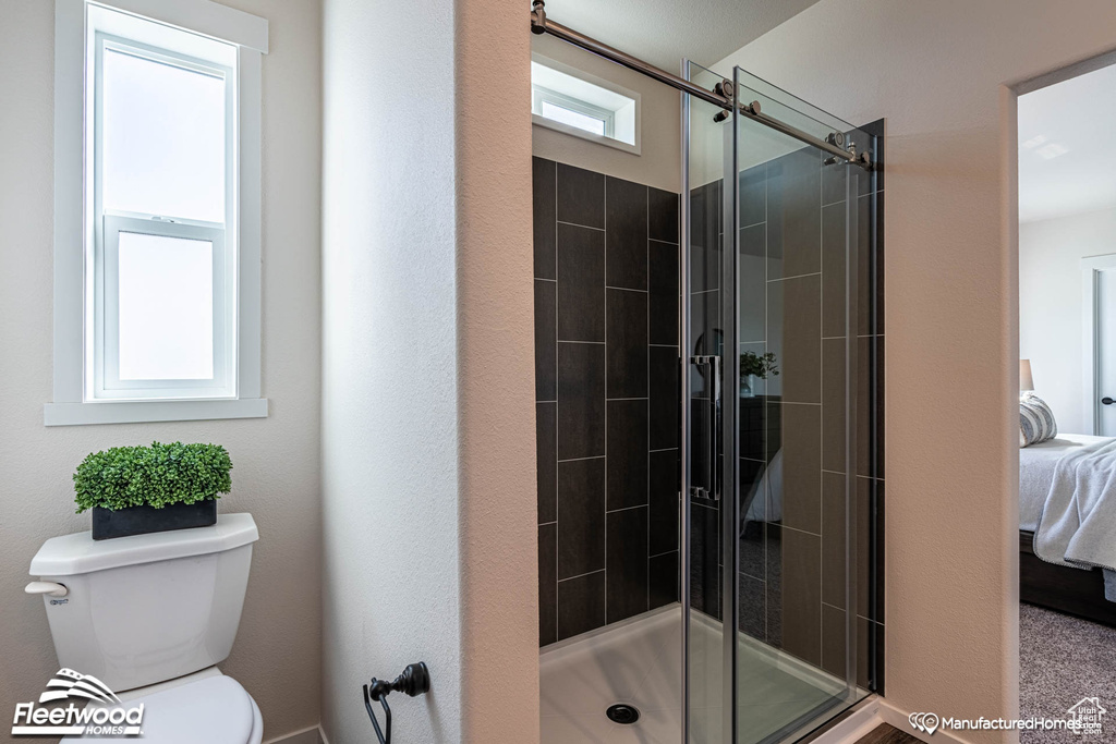 Bathroom with toilet and an enclosed shower